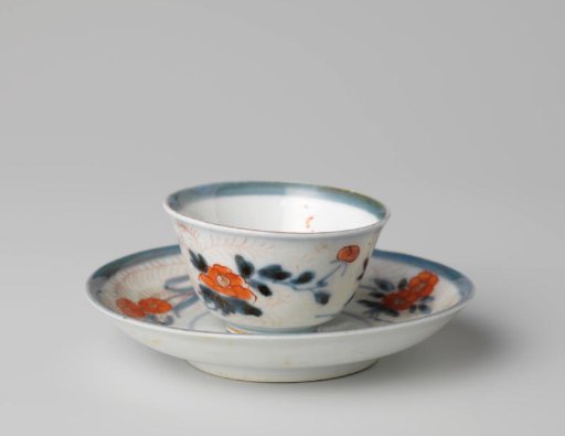 Bell-shaped cup and saucer with flower sprays and foliate scrolls