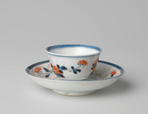 Bell-shaped cup and saucer with flower sprays and foliate scrolls
