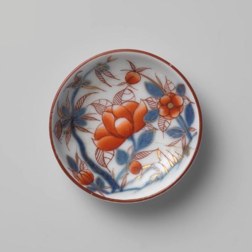 Miniature saucer with flowering plants