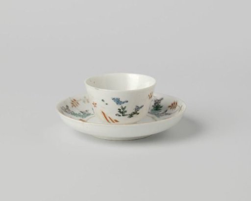 Cup and saucer with lozenges and flowering plants