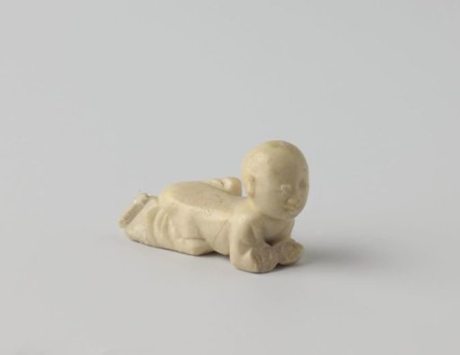 A crawling child figure in soapstone