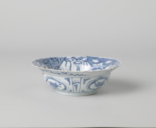 Klapmuts bowl with a pheasant on a rock near flowering plants