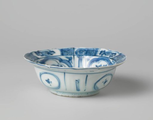 Klapmuts bowl with a bird on a rock near flowering plants
