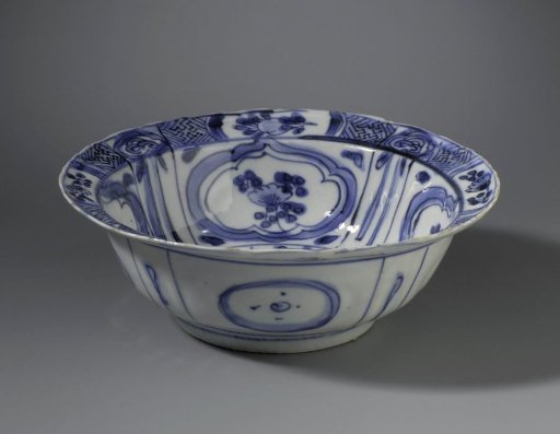 Klapmuts bowl with a bird on a rock near flowering plants