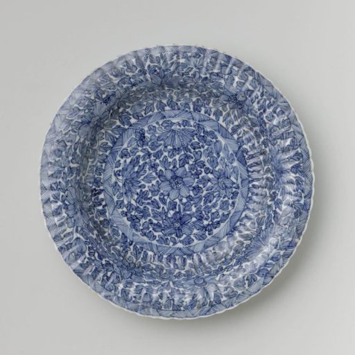Plate with fluted sides and continuous flower pattern