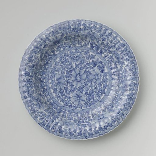Plate with fluted sides and continuous flower pattern