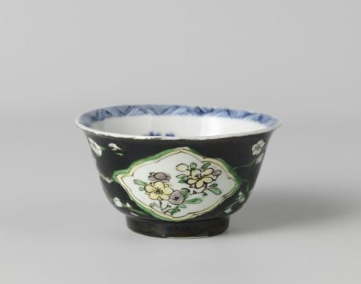 Cup with flower sprays in panels on a black ground