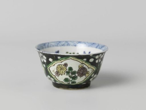Cup with flower sprays in panels against a black ground