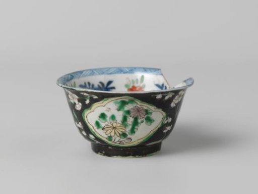 Cup with flower sprays in panels against a black ground