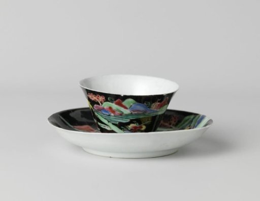 Cup and saucer with deer in a water landscape on a black ground