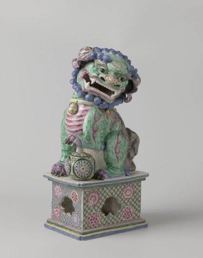 Figure of a shishi with its paw on a pierced ball