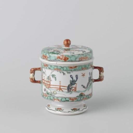 Covered jar with peacocks and flowering plants in a fenced garden