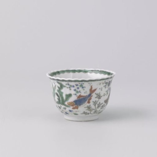 Cup with fish between water plants