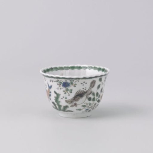 Cup with fish between water plants