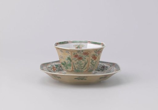 Octagonal cup and saucer with light brown, animals and flower sprays