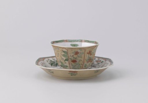 Octagonal cup and saucer with light brown, animals and flower sprays