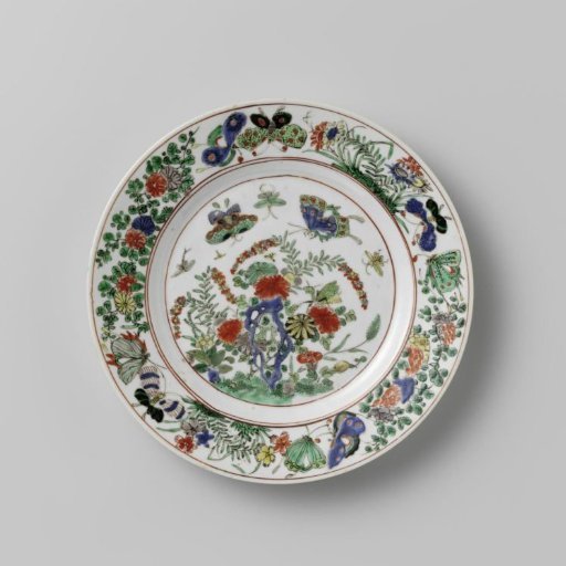Plate with rock, butterflies and flowering plants