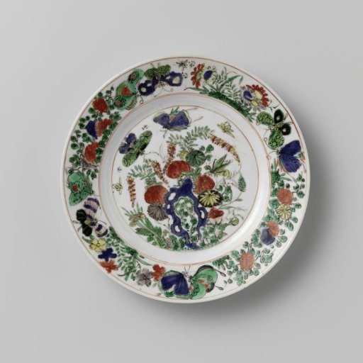 Plate with rock, butterflies and flowering plants