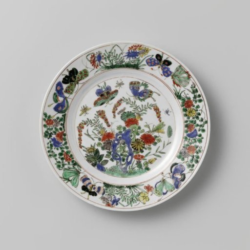Plate with rock, butterflies and flowering plants