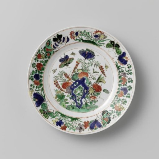 Plate with rock, butterflies and flowering plants