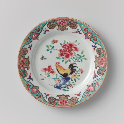 Plate with a cock on a rock near flowering plants