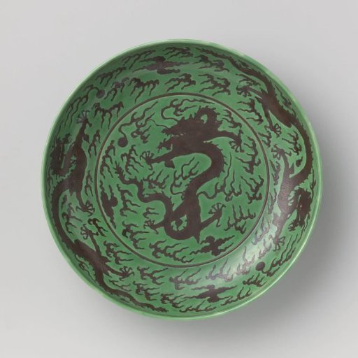 Saucer-dish with pearl chasing dragons against a green ground