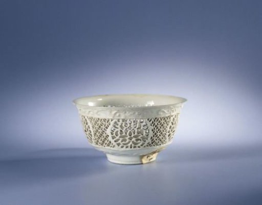 White bowl with pierced sides and flower sprays in relief
