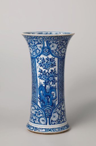 Beaker vase with flowering plants near a rock, diaper pattern and floral scrolls