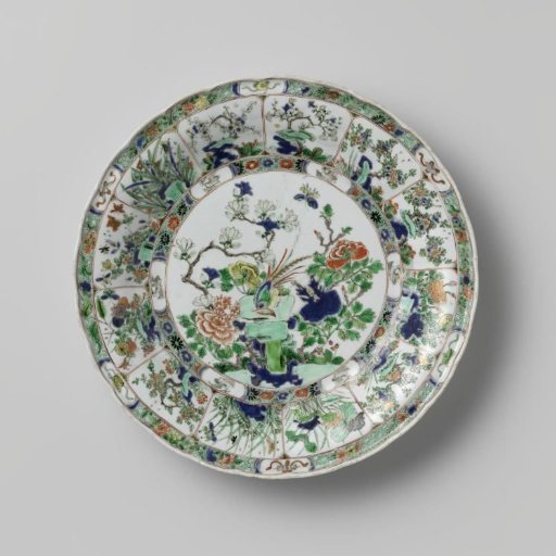 Dish with a pheasant on a rock surrounded by flowering plants