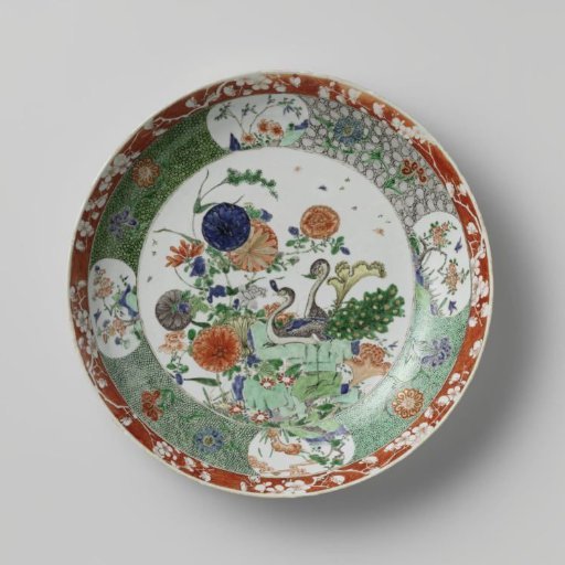 Saucer-dish with two peacocks, rocks and flowering plants