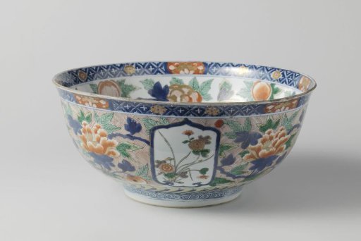 Bowl with large flower sprays, flowering plants and fish