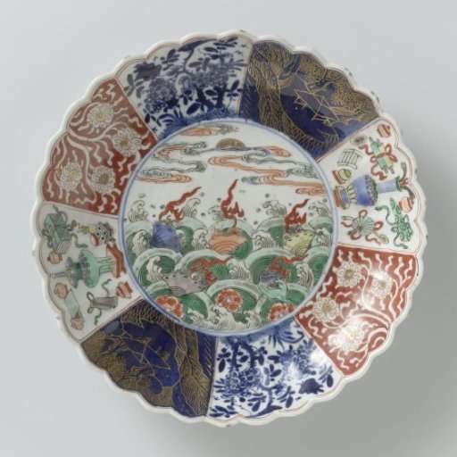 Saucer-dish with fluted sides and flowers and shellfish above waves