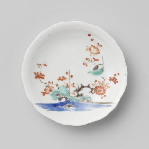 Scalloped saucer with rocks, prunus and bird