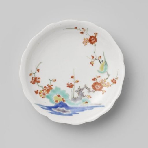 Scalloped saucer with rocks, prunus and bird