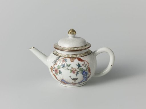 Teapot with a crane near a peony plant and rock