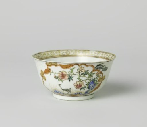 Bell-shaped cup with a crane near a peony plant and rock