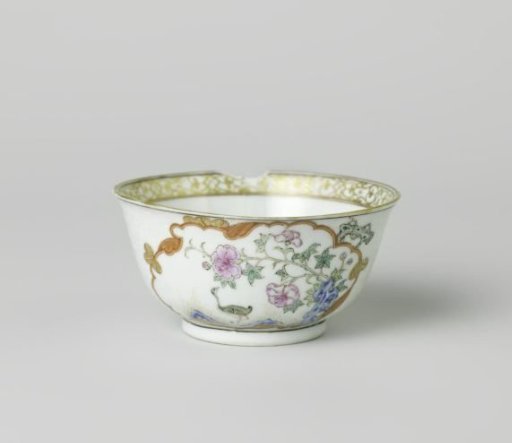 Bell-shaped cup with a crane near a peony plant and rock
