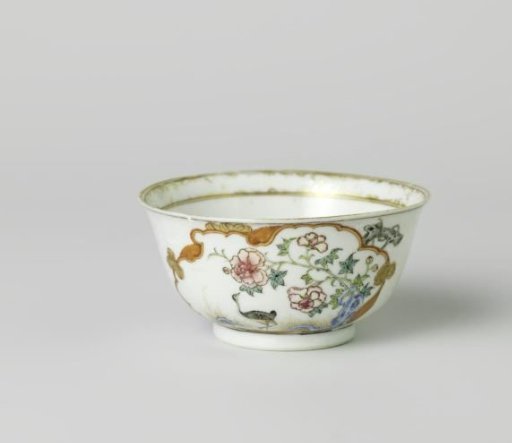 Bell-shaped cup with a crane near a peony plant and rock