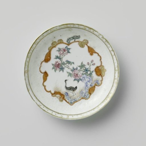 Saucer with a crane near a peony plant and rock