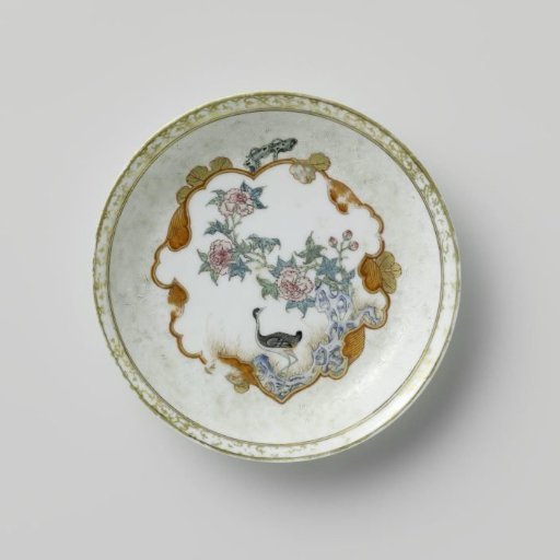 Saucer with a crane near a peony plant and rock