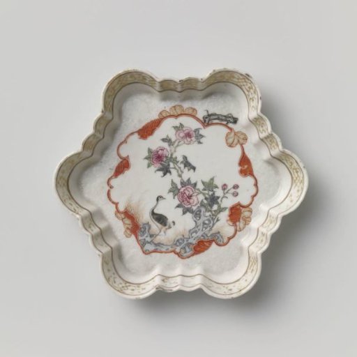 Hexagonal teapot stand with a crane near a peony plant and rock