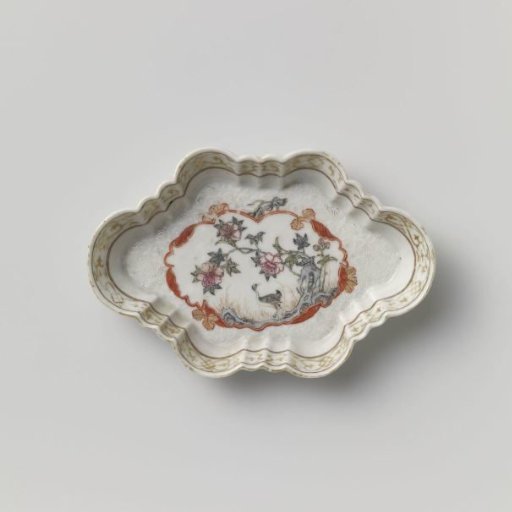 Spoon tray with a crane near a peony plant and rock