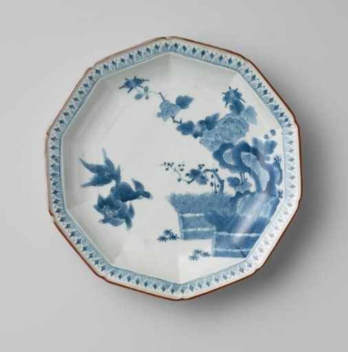 Decagonal dish with a shishi near flowering trees, rocks and brushwood fences