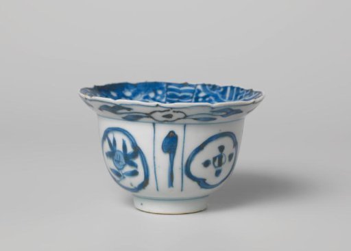 Bowl (klapmuts) with a bird on a rock near flowering plants and a panel decoration