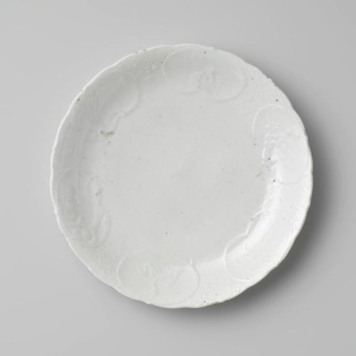 Saucer-dish with in relief a crane, hoo-bird, auspicious symbols and the 'three friends' in panels