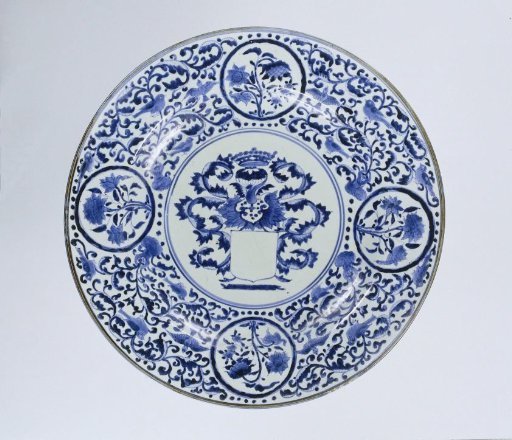 Dish with an empty coat of arms, flowering plants and scrolls
