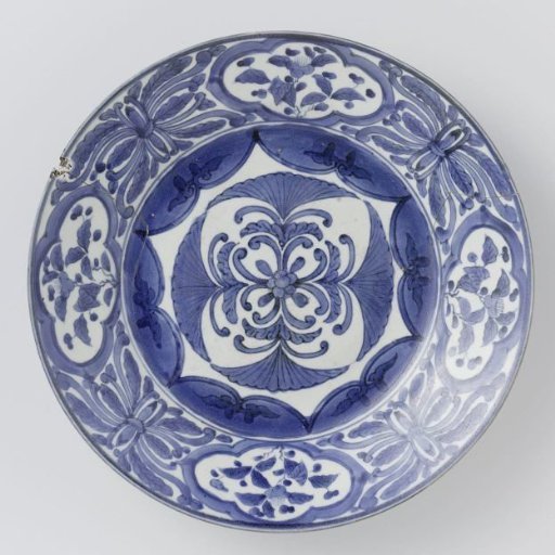 Dish with stylised flowers, floral scrolls and flowering plants in panels