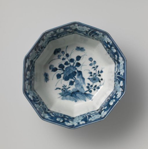 Decagonal bowl with flowering plants near rocks, butterflies and floral scrolls