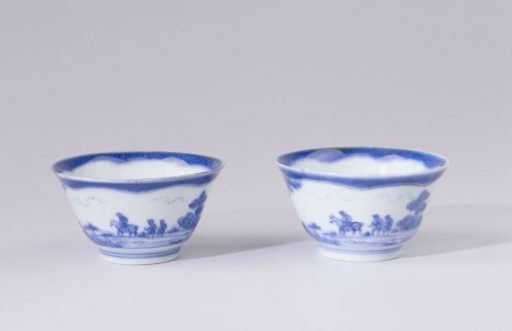 Bell-shaped cup with figures in a landscape with trees and rocks