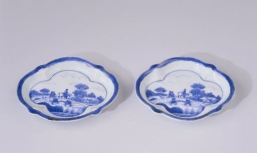 Saucer with figures on a bridge in a water landscape with trees and houses